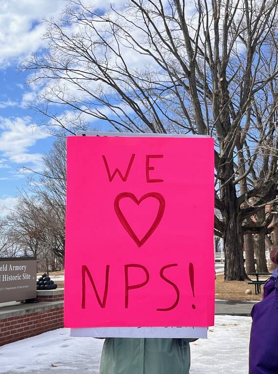 <p>A "We love NPS" sign during a rally at Springfield Armory National Historic Site in Massachusetts in early March 2025. </p>
